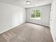 This bedroom has carpet flooring and a window view at 2734 Amber Springs Way, Buford, GA 30519