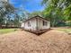 A charming home showing the side of the house with a backdrop of lush greenery at 2734 Amber Springs Way, Buford, GA 30519