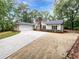 Inviting home with fresh landscaping, a stone chimney, and an attached garage at 2734 Amber Springs Way, Buford, GA 30519