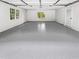 Spacious garage with grey epoxy flooring, door, and windows at 2734 Amber Springs Way, Buford, GA 30519