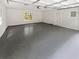 Spacious garage with grey epoxy flooring, door, and windows at 2734 Amber Springs Way, Buford, GA 30519