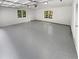 Spacious garage with grey epoxy flooring, door, and windows at 2734 Amber Springs Way, Buford, GA 30519