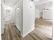 Hallway featuring wood-look flooring, closet and white trim at 2734 Amber Springs Way, Buford, GA 30519
