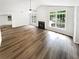 Spacious living room features wood-look flooring, fireplace, and bright windows at 2734 Amber Springs Way, Buford, GA 30519