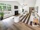 Bright, staged living room with fireplace, vaulted ceiling, and large windows at 2734 Amber Springs Way, Buford, GA 30519