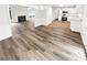 Open floor plan with eat-in kitchen, living room with fireplace, and luxury vinyl plank flooring at 2734 Amber Springs Way, Buford, GA 30519