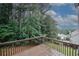 A view from a wood deck showing a wooded backyard and a partial view of the house at 365 Hunt Creek Dr, Acworth, GA 30101
