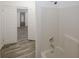 This bathroom features a shower with white tiled walls and modern fixtures, with tile flooring throughout at 365 Hunt Creek Dr, Acworth, GA 30101