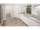 Bright bathroom features a double vanity, granite countertop, walk-in shower, and wood-style tile flooring at 365 Hunt Creek Dr, Acworth, GA 30101