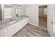 Bright bathroom featuring a double vanity with granite counters and grey wood-style tile floor at 365 Hunt Creek Dr, Acworth, GA 30101