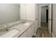 Bright bathroom featuring double sinks, granite countertops, and wood-style tile floor at 365 Hunt Creek Dr, Acworth, GA 30101