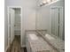 Bathroom featuring double sinks, granite countertops, and a tub-shower combo at 365 Hunt Creek Dr, Acworth, GA 30101