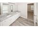 Bathroom featuring dual sinks, granite countertop, grey floor tile, and access to the bedroom at 365 Hunt Creek Dr, Acworth, GA 30101