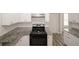 Modern kitchen with granite counters, stainless steel appliances and white tile backsplash at 365 Hunt Creek Dr, Acworth, GA 30101