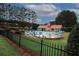 A community pool with a mushroom water feature, poolside seating and a red-roofed building surround it at 365 Hunt Creek Dr, Acworth, GA 30101