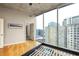 Bedroom with hardwood floors and large windows providing abundant natural light and city views at 44 Peachtree Ne Pl # 1824, Atlanta, GA 30309