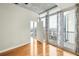 Bedroom with hardwood floors, a balcony, and floor-to-ceiling windows at 44 Peachtree Ne Pl # 1824, Atlanta, GA 30309