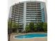 Exterior view of the building with a pool and lounge chairs at 44 Peachtree Ne Pl # 1824, Atlanta, GA 30309