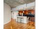 Modern kitchen and adjacent living area featuring hardwood floors and stainless steel appliances and breakfast bar at 44 Peachtree Ne Pl # 1824, Atlanta, GA 30309