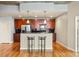 Modern kitchen with stainless steel appliances, wooden cabinets, breakfast bar, and access to living area at 44 Peachtree Ne Pl # 1824, Atlanta, GA 30309