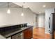 Modern kitchen with stainless steel appliances, granite countertops, tiled backsplash, and breakfast bar at 44 Peachtree Ne Pl # 1824, Atlanta, GA 30309