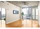 Bright living room featuring hardwood floors, large windows, and sliding glass door to balcony with city views at 44 Peachtree Ne Pl # 1824, Atlanta, GA 30309