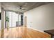 Bright living room featuring hardwood floors, large windows, and sliding glass door to balcony with city views at 44 Peachtree Ne Pl # 1824, Atlanta, GA 30309
