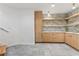 Finished basement features modern light wood cabinets, open shelving, and tile flooring at 612 Champions Dr, Mcdonough, GA 30253