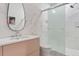 Modern bathroom features a sleek vanity, shower with glass doors, and a unique textured wall design at 612 Champions Dr, Mcdonough, GA 30253
