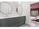 Modern bathroom featuring double sink vanity, stylish lighting and a view to an adjacent bedroom at 612 Champions Dr, Mcdonough, GA 30253