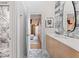Bright bathroom with marble floors, a long vanity, stylish mirror and decorative artwork, and view to bedroom at 612 Champions Dr, Mcdonough, GA 30253
