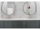 Contemporary bathroom with double sinks and mirrors, featuring elegant vanity and modern fixtures at 612 Champions Dr, Mcdonough, GA 30253