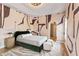 Charming bedroom with bold abstract wallpaper, tray ceiling, a closet, and hardwood floors at 612 Champions Dr, Mcdonough, GA 30253