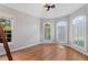 Bright bedroom featuring shuttered windows, hardwood floors, and neutral walls at 612 Champions Dr, Mcdonough, GA 30253