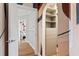 View from door to the main bedroom with hardwood floors, decorative artwork and large walk-in closet at 612 Champions Dr, Mcdonough, GA 30253