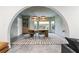 Arched dining room featuring pendant lighting above a wooden table and seats with an area rug at 612 Champions Dr, Mcdonough, GA 30253
