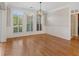 Bright dining room featuring elegant millwork, hardwood floors, and contemporary lighting at 612 Champions Dr, Mcdonough, GA 30253