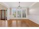 Bright dining room featuring elegant millwork, hardwood floors, and contemporary lighting at 612 Champions Dr, Mcdonough, GA 30253