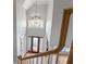 Two-story foyer with hardwood floors, transom windows, and a chandelier at 612 Champions Dr, Mcdonough, GA 30253