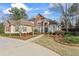 Stunning front exterior featuring lush landscaping and a welcoming driveway at 612 Champions Dr, Mcdonough, GA 30253