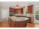 Kitchen island with granite countertop, cooktop, and stainless steel appliances at 612 Champions Dr, Mcdonough, GA 30253