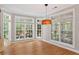 Eat-in kitchen with hardwood floors, large windows, and custom pendant lighting at 612 Champions Dr, Mcdonough, GA 30253