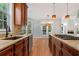 Gourmet kitchen with granite counters, stainless appliances and hardwood floors at 612 Champions Dr, Mcdonough, GA 30253
