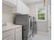 Laundry room with sink, cabinets and washer/dryer at 612 Champions Dr, Mcdonough, GA 30253