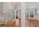 Bright living room features hardwood floors, white trim, and an elegant chandelier at 612 Champions Dr, Mcdonough, GA 30253