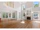 Living room featuring hardwood floors, fireplace, high ceilings, and large windows at 612 Champions Dr, Mcdonough, GA 30253