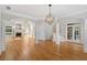 Open-concept living room with hardwood floors, fireplace, and lots of natural light at 612 Champions Dr, Mcdonough, GA 30253