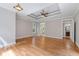 Large main bedroom featuring hardwood floors, a tray ceiling, and access to the main bath at 612 Champions Dr, Mcdonough, GA 30253