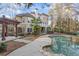 View of an outdoor space with a pool, stone-lined spa, and an outdoor kitchen area ideal for entertaining at 612 Champions Dr, Mcdonough, GA 30253