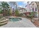Enjoy a backyard oasis with a stone-lined pool, spa, and outdoor kitchen area perfect for entertaining at 612 Champions Dr, Mcdonough, GA 30253